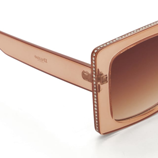 Take your edit to the next level with our Glitzy sunglasses. This trend-led frame features a gradient lens and a thick frame that is adorned with a diamante inlay across the top and side. So, whether you're strolling along the beach or navigating the city streets, Glitzy is certain to add a touch of glamour to your warm-weather ensembles.