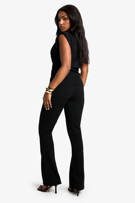 Sleek scuba crepe co-ord set featuring a top with shoulder pads
        High neck design for a sophisticated look
        Flared trousers to elongate the silhouette
        Fitted waist to accentuate your curves
        Versatile two-piece ensemble for effortless styling
    
    Make a statement on your next night out with this striking scuba crepe co-ord set. The sleeveless top with its high neck and structured shoulder pads creates a bold, confident silhouette, while the flared trousers add a touch of retro glamour. Perfect for the fashion-forward Boohoo girl who wants to turn heads at the club or bar. Style with strappy heels and statement jewellery for a look that commands attention. The fitted waist cinches you in at just the right spot, creating a flattering hourglass shape. Whether you're meeting friends for drinks or dancing the night away, this co-ord set offers both comfort and style. Its versatility allows for easy mixing and matching with other pieces in your wardrobe, making it a go-to choice for various evening occasions.
