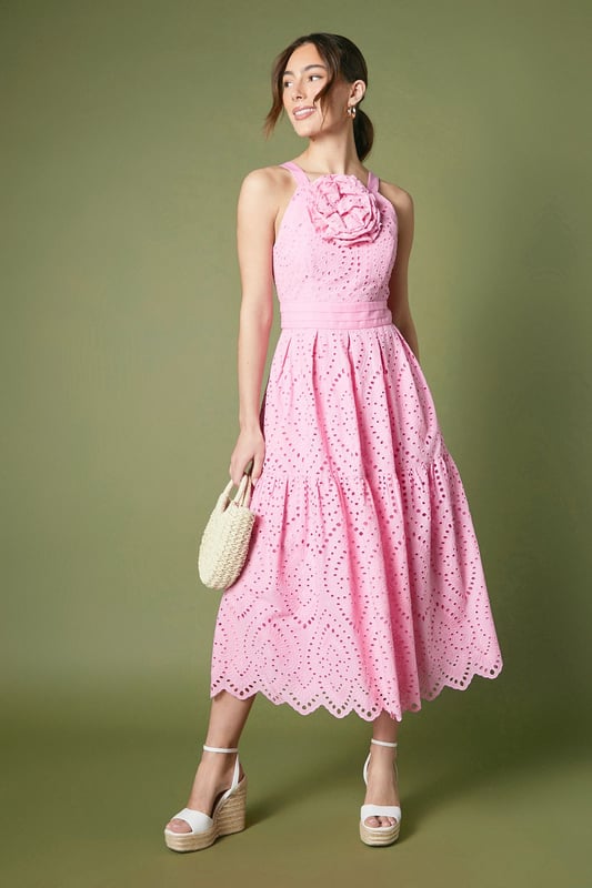 Striking disc sequin embellishment creates a dazzling light-catching effect
        Elegant fitted silhouette with a flattering midi length
        Statement floral corsage detail at the neckline adds sophisticated dimension
        Delicate scalloped hem with intricate eyelet pattern throughout
        Stylish cut-out back detail with secure fastening for a contemporary twist
    
    Make an unforgettable entrance at your next special occasion in this exquisite Coast midi dress. The fitted bodice gracefully highlights your silhouette while the eye-catching disc sequins catch and reflect light with every movement. Perfect for weddings or race day events, this dress combines timeless elegance with contemporary design through its distinctive floral corsage and modern cut-out back detail. Style with neutral platform sandals and a structured clutch as shown for daytime sophistication, or transition to evening events with metallic strappy heels and statement earrings. The scalloped eyelet pattern adds textural interest and a feminine touch that ensures you'll stand out for all the right reasons. This versatile piece works beautifully for garden parties, formal receptions or any event where you wish to convey refined glamour.