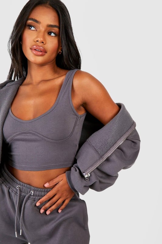 Three-piece tracksuit featuring a crop top, hoodie, and wide-leg trousers
        Seam detail adds a stylish touch to the ensemble
        Fleece-back fabric for comfort and warmth
        Hooded jacket with full-length zip closure
        Wide-leg trousers with an adjustable waistband for a customisable fit
    
    Embrace laid-back chic with this versatile three-piece tracksuit from Boohoo. Perfect for those who want to stay on-trend whilst prioritising comfort, this set is ideal for a range of casual occasions. The crop top can be worn alone on warmer days or layered under the hoodie when the temperature drops. The wide-leg trousers offer a contemporary silhouette that pairs beautifully with trainers for a street-style inspired look. For a casual day out, throw on the full set with some chunky jewellery and a cross-body bag. Alternatively, mix and match the pieces with other items in your wardrobe - try the hoodie with skinny jeans or the trousers with a fitted tee for endless styling possibilities. Whether you're heading to a laid-back brunch, running errands, or enjoying a cosy night in, this tracksuit has got you covered with its blend of style and comfort.