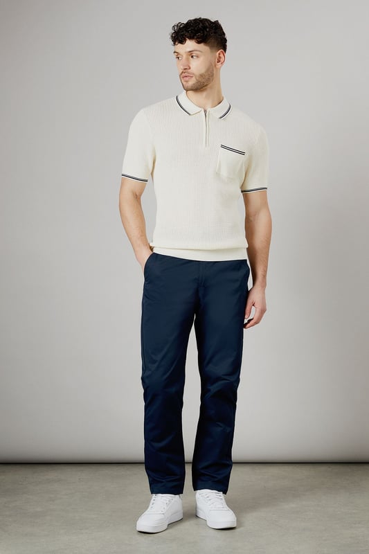 Half elasticated waistband for comfortable all-day wear
        Slim fit design offers a modern, streamlined silhouette
        Practical back pockets with button closure for secure storage
        Clean-cut finish with no visible cuffs for a sleek appearance
        Versatile woven fabric that maintains its shape throughout the day
    
    These half elasticated waist chinos strike the perfect balance between comfort and style. The slim fit contours to your body without feeling restrictive, making them ideal for both casual outings and relaxed work environments. Pair them with a knitted polo shirt as shown for a smart-casual look that works brilliantly for weekend pub visits or family gatherings. The clean lines and classic design make these chinos a wardrobe essential that transitions effortlessly from daytime errands to evening socialising. Team with white trainers for a fresh, contemporary finish, or dress them up with desert boots for more formal occasions. These Burton chinos offer the reliability and timeless appeal that complements an active lifestyle without compromising on style.