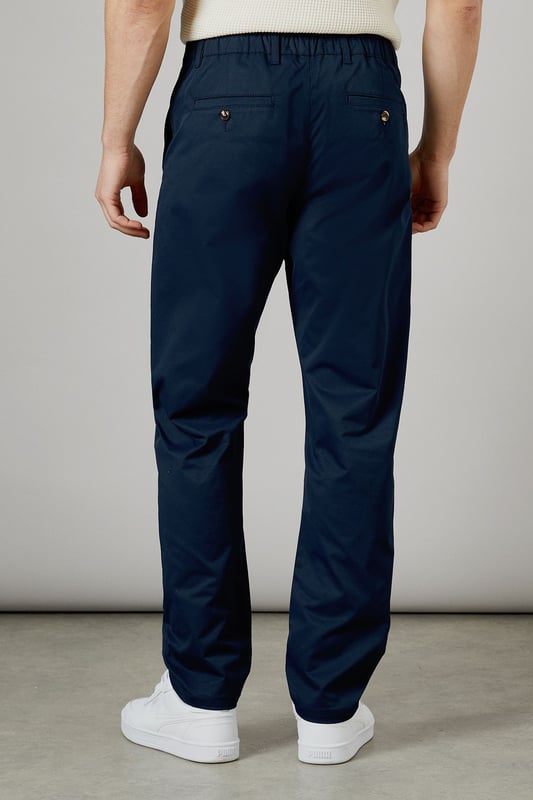 Half elasticated waistband for comfortable all-day wear
        Slim fit design offers a modern, streamlined silhouette
        Practical back pockets with button closure for secure storage
        Clean-cut finish with no visible cuffs for a sleek appearance
        Versatile woven fabric that maintains its shape throughout the day
    
    These half elasticated waist chinos strike the perfect balance between comfort and style. The slim fit contours to your body without feeling restrictive, making them ideal for both casual outings and relaxed work environments. Pair them with a knitted polo shirt as shown for a smart-casual look that works brilliantly for weekend pub visits or family gatherings. The clean lines and classic design make these chinos a wardrobe essential that transitions effortlessly from daytime errands to evening socialising. Team with white trainers for a fresh, contemporary finish, or dress them up with desert boots for more formal occasions. These Burton chinos offer the reliability and timeless appeal that complements an active lifestyle without compromising on style.