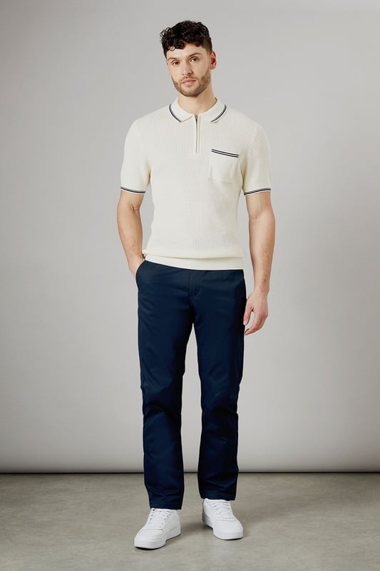 Half elasticated waistband for comfortable all-day wear
        Slim fit design offers a modern, streamlined silhouette
        Practical back pockets with button closure for secure storage
        Clean-cut finish with no visible cuffs for a sleek appearance
        Versatile woven fabric that maintains its shape throughout the day
    
    These half elasticated waist chinos strike the perfect balance between comfort and style. The slim fit contours to your body without feeling restrictive, making them ideal for both casual outings and relaxed work environments. Pair them with a knitted polo shirt as shown for a smart-casual look that works brilliantly for weekend pub visits or family gatherings. The clean lines and classic design make these chinos a wardrobe essential that transitions effortlessly from daytime errands to evening socialising. Team with white trainers for a fresh, contemporary finish, or dress them up with desert boots for more formal occasions. These Burton chinos offer the reliability and timeless appeal that complements an active lifestyle without compromising on style.