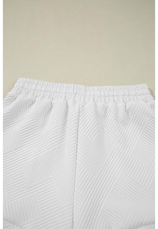 Our styles are designed with a trendy fitted look in mind following an international size standard. For the best fit we suggest choosing one size up from your usual. Be sure to check our sizing chart to find your perfect match!
  White textured short set
  Half
  zip cropped tank top
  Matching drawstring shorts
  Made from buttery soft fabric
  Ideal for casual wear
  Pairs well with sneakers and boots
Material: 97% Polyester 3% Elastane