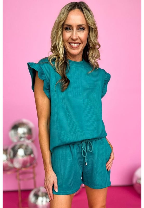 Our styles are designed with a trendy fitted look in mind following an international size standard. For the best fit we suggest choosing one size up from your usual. Be sure to check our sizing chart to find your perfect match!
  Two
  piece set includes a ruffled shoulder top and drawstring shorts
  Made from quilted fabric
  Sleeveless design
  Shorts with a drawstring waist
  Suitable for casual occasions
  Interchangeable pieces that can be worn with other wardrobe staples
Material: 95% Polyester 5% Elastane