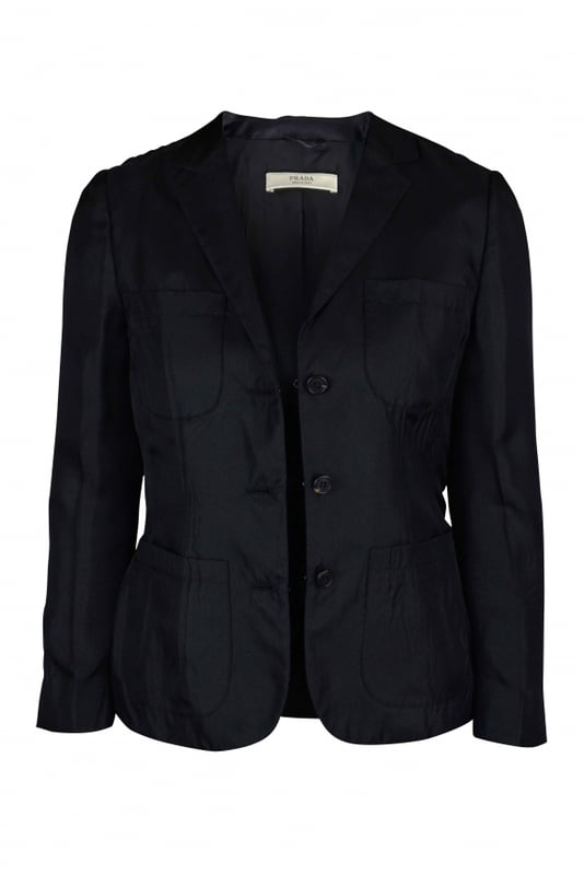 Chaqueta ligera negra de Prada con cuello.Varios bolsillos en la parte delantera.Cierre con botones.Botones en la parte inferior de las mangas.100% seda.Made in Italy.