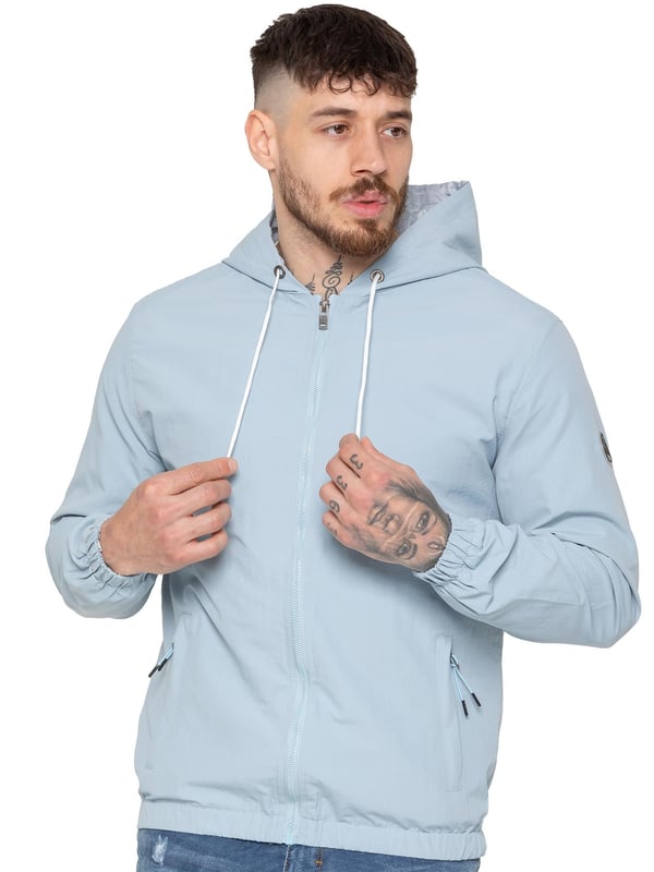 The Enzo Milano Men's Windbreaker Jacket offers a sleek, lightweight design with a regular fit. Made from durable tech fabric, it features a full zip, adjustable drawstring hood, and elasticated cuffs for added comfort and protection. With two concealed zip pockets, a single inner pocket, and an elasticated hem with a drawcord toggle, this water-Repellent jacket is perfect for everyday wear in light rain or windy conditions. Finished with the signature Enzo Milano rubber badge for a stylish touch.