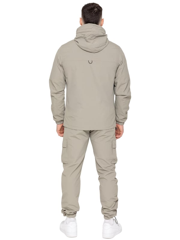 The Enzo Milano Men’s Lightweight Cargo Jacket is a sleek, functional outer layer made from water-repellent crushed poly fabric with a breathable mesh lining for all-day comfort. Designed in a regular fit, it features a full zip front, high neck, and adjustable drawcord hood for versatile coverage. With two Velcro chest pockets, two zippered side pockets, elasticated cuffs, and an adjustable drawcord hem, it offers both style and practicality—perfect for layering in changing weather.