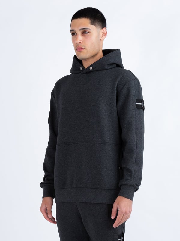 This premium hoodie from LUKE is crafted from a smooth luxe touch fabrication, cut to a relaxed fit and detailed with dark pewter gloss trims. It features a zip pocket on the right sleeve and handy lower front pockets. The hood is styled with a magnetic snap button at the front and the left sleeve is styled with a detachable striped tape detailed with the brands iconic shiny raised metal lion felt badge.