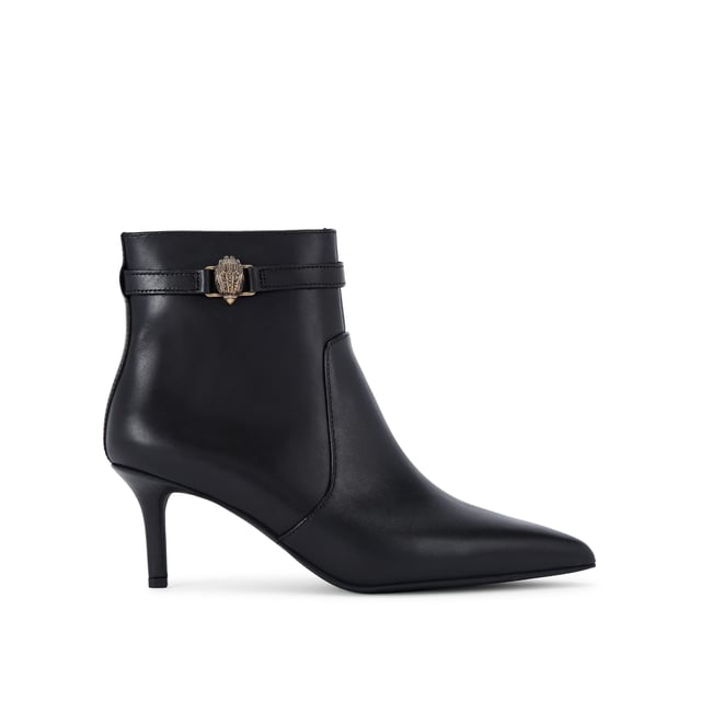 This Kurt Geiger Kensington Flexi Ankle boot features a sleek black leather upper with pointed toe. There is an antiqued brass eagle head on the slim ankle strap. Heel height: 6.5cm.
