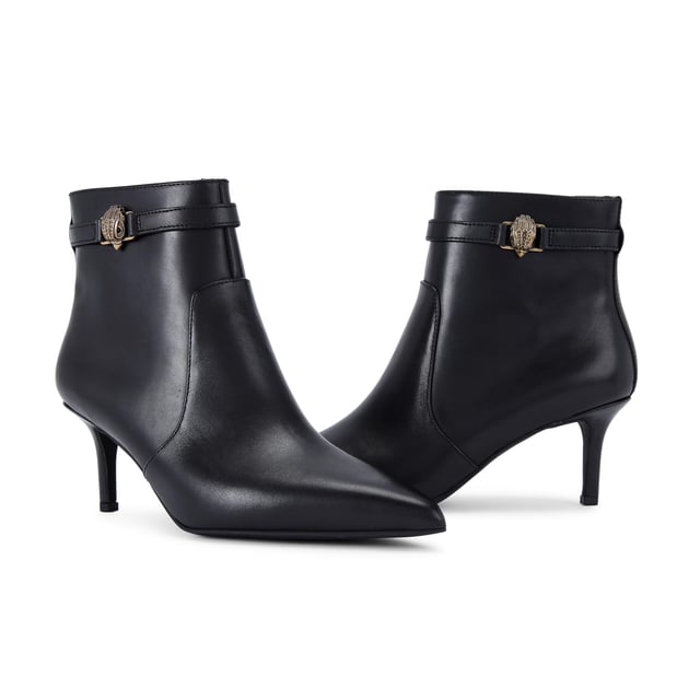 This Kurt Geiger Kensington Flexi Ankle boot features a sleek black leather upper with pointed toe. There is an antiqued brass eagle head on the slim ankle strap. Heel height: 6.5cm.
