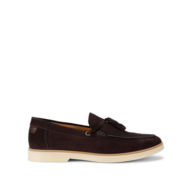 KG Kurt Geiger Suede Ronan Slip On The KG Kurt Geiger Ronan is a slip-on shoe crafted from a brown suede leather. There are antiqued brass branded eyelets on each side with a tassel detail on the toe.