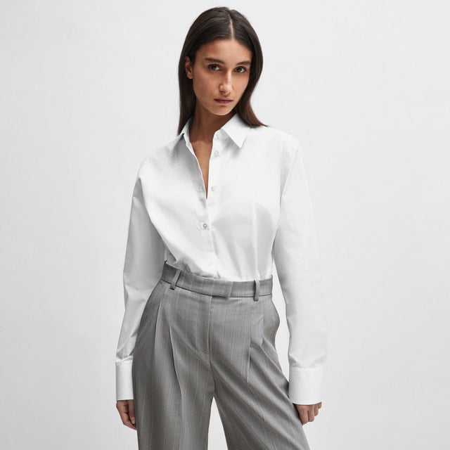 Womens NAOMI x BOSS Cotton Bodysuit in white.An effortless bodysuit with blouse styling by BOSS Womenswear  crafted in cotton and topped with a point collar. Specially designed with a wrinkle-free  bacteria-resistant finish. Part of an exclusive capsule  co-created with Naomi Campbell  designed with elegance  confidence  and on-the-go ease in mind. - Point collar- Long sleeves- Button cuffs- Main material: 100% Cotton.  Lower part: 91% Polyamide  9% Elastane.  Hand wash - Dry clean.- Ref: 50515405-100
