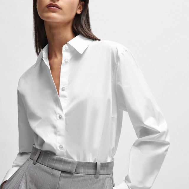Womens NAOMI x BOSS Cotton Bodysuit in white.An effortless bodysuit with blouse styling by BOSS Womenswear  crafted in cotton and topped with a point collar. Specially designed with a wrinkle-free  bacteria-resistant finish. Part of an exclusive capsule  co-created with Naomi Campbell  designed with elegance  confidence  and on-the-go ease in mind. - Point collar- Long sleeves- Button cuffs- Main material: 100% Cotton.  Lower part: 91% Polyamide  9% Elastane.  Hand wash - Dry clean.- Ref: 50515405-100