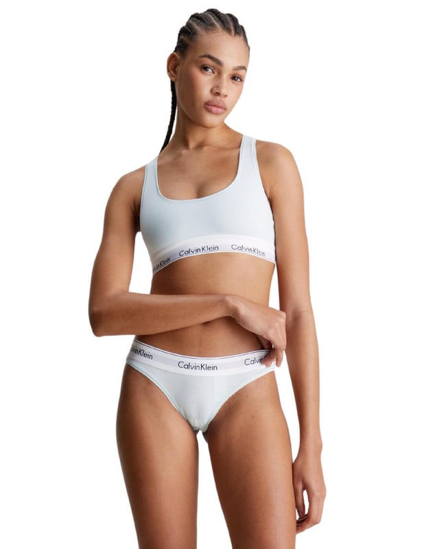 Calvin Klein Modern Cotton Thong Ladies, say goodbye to uncomfortable and unflattering lingerie and hello to the Calvin Klein Modern Cotton thong. Its low-rise fit and minimal rear coverage make it discreet yet fashionably versatile, ideal for any look or occasion. Crafted from a breathable cotton blend, this thong promises day-long comfort, blending seamlessly under any outfit with its sleek, opaque design. Adorned with the iconic Calvin Klein logo waistband, it assures a luxe feel while ensuring a perfect fit. Ideal for complementing with other pieces from Calvin Klein's lingerie line, it's a must-have for those prioritising comfort without compromising on style. Elevate your lingerie collection with this essential piece – your go-to for confidence and elegance every day.