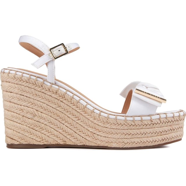 These Gia Bow platform wedges are beautiful, stylish summer sandals to elevate your outfit to new heights. Featuring a strappy white upper with a delicate buckle closure and ankle strap for a perfect, elegant fit. The gorgeous Ted Baker branded gold metal bow adds a touch of glam and the espadrille wedge sole a generous lift to your ensemble.