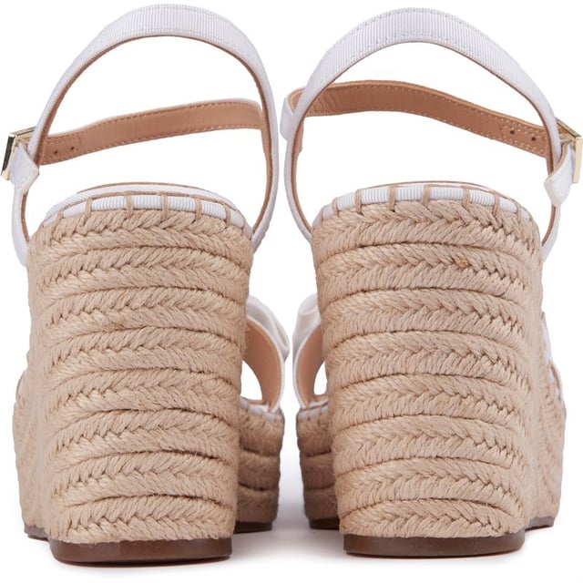These Gia Bow platform wedges are beautiful, stylish summer sandals to elevate your outfit to new heights. Featuring a strappy white upper with a delicate buckle closure and ankle strap for a perfect, elegant fit. The gorgeous Ted Baker branded gold metal bow adds a touch of glam and the espadrille wedge sole a generous lift to your ensemble.
