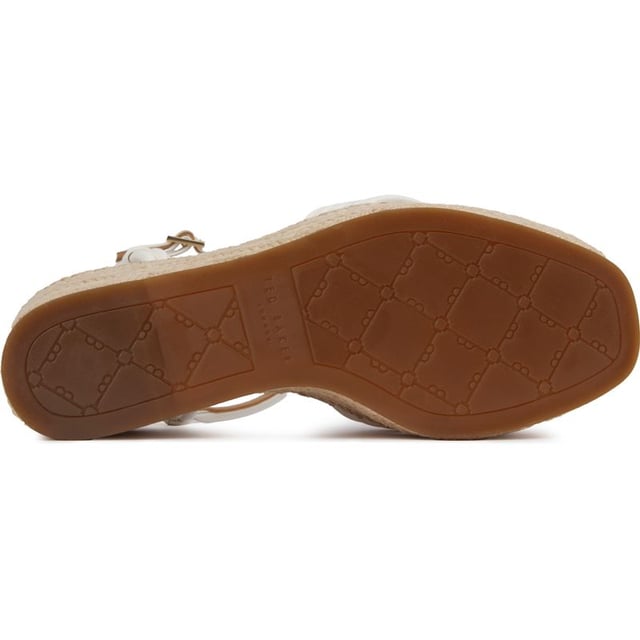 These Gia Bow platform wedges are beautiful, stylish summer sandals to elevate your outfit to new heights. Featuring a strappy white upper with a delicate buckle closure and ankle strap for a perfect, elegant fit. The gorgeous Ted Baker branded gold metal bow adds a touch of glam and the espadrille wedge sole a generous lift to your ensemble.