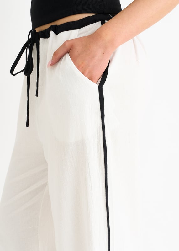 Sie suchen eine modische und bequeme Hose? Dann ist unsere Leinen-Look-Kontraststreifen-Hose mit Kordelzug genau das Richtige für Sie! Diese Hose aus leichtem Leinenstoff mit schickem Kontraststreifenmuster ist sowohl modisch als auch funktionell. Der Kordelzug in der Taille sorgt für eine individuelle Passform und ganztägigen Komfort. Ergänzen Sie Ihre Garderobe noch heute mit dieser trendigen Hose.