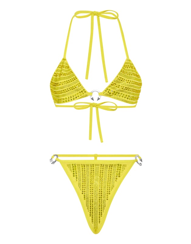 Verfraaid  Ontdek de glamourstijl met deze bikini van lycra versierd met kristallen applicaties.   Bijpassend gekleurd lycra bezet met strass   Driehoekig topje met strikbandjes   Ring met juwelenpiercing in de nek   Strikstring met juwelenpiercing   Stiksels met twee naalden