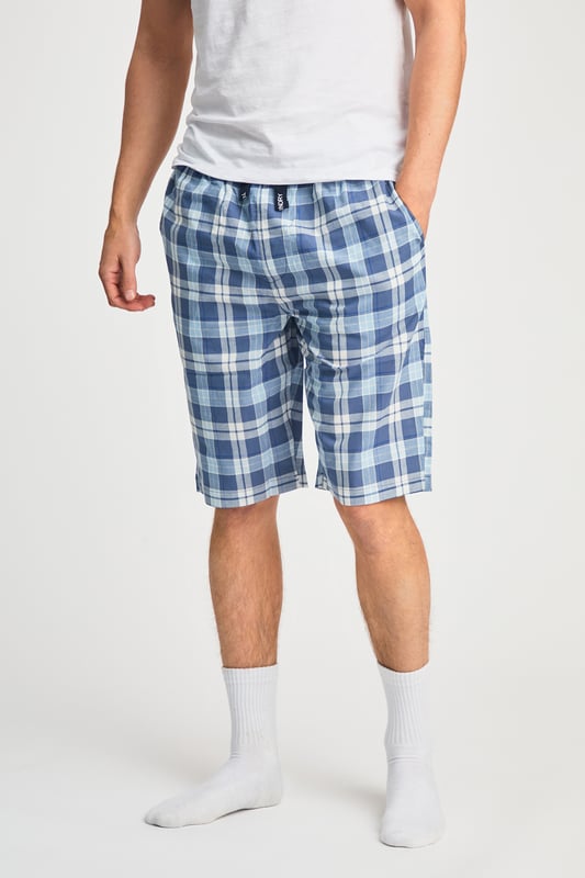 These Tokyo Laundry boxer-style checked lounge shorts are made from 100% cotton with a garment-washed finish for ultimate comfort. Designed with an elastic waistband and adjustable drawstring, they offer a relaxed fit, making them perfect for everyday lounging. Stylish, breathable, and effortlessly casual.