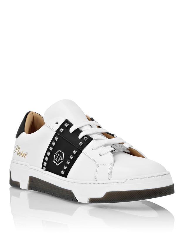 Discover the uniqueness of these lo-top sneakers with studs decoration. Look at the details.   Nappa upper    Rubber strap featuring studs and the nickel-plated logo   Contrasting colored heel tab   Nickel-plated spoiler on heel stabilizer   Hi-tech, ergonomic, ultra lightweight, shock-absorbing rubberized midsole   Grooved outsole for maximum grip   Padded nappa lining and removable insole
