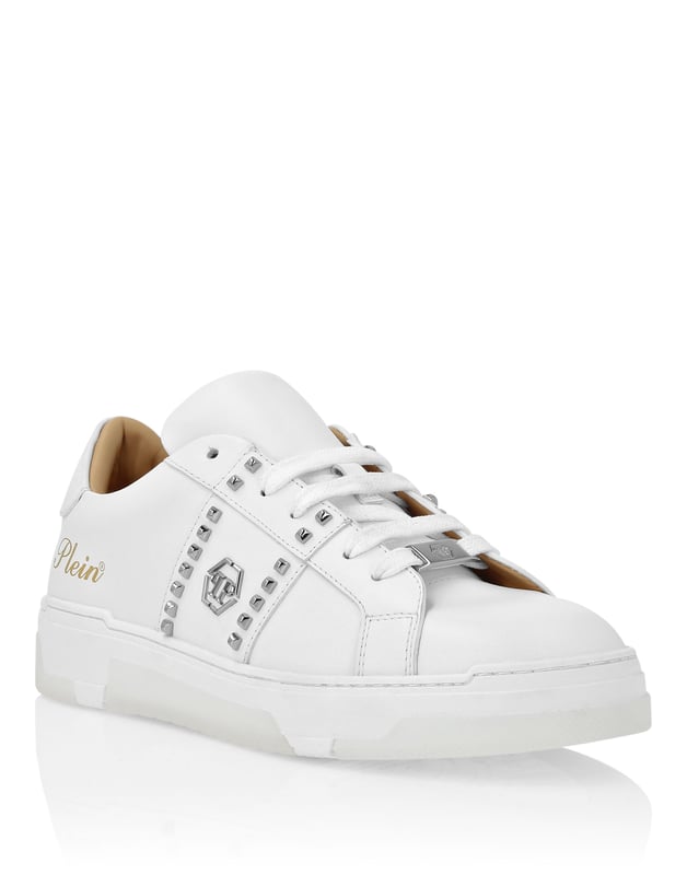 Discover the uniqueness of these lo-top sneakers with studs decoration. Look at the details.   Nappa upper    Rubber strap featuring studs and the nickel-plated logo   Contrasting colored heel tab   Nickel-plated spoiler on heel stabilizer   Hi-tech, ergonomic, ultra lightweight, shock-absorbing rubberized midsole   Grooved outsole for maximum grip   Padded nappa lining and removable insole