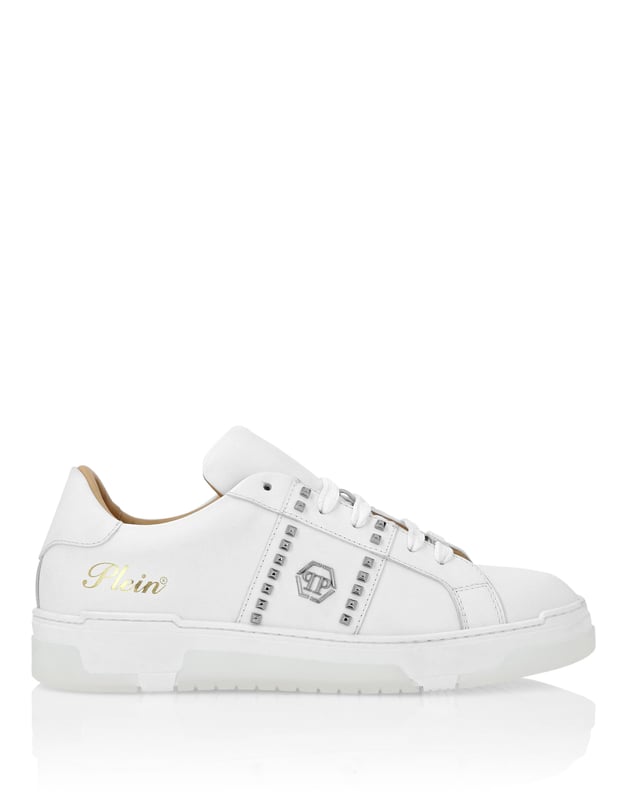 Discover the uniqueness of these lo-top sneakers with studs decoration. Look at the details.   Nappa upper    Rubber strap featuring studs and the nickel-plated logo   Contrasting colored heel tab   Nickel-plated spoiler on heel stabilizer   Hi-tech, ergonomic, ultra lightweight, shock-absorbing rubberized midsole   Grooved outsole for maximum grip   Padded nappa lining and removable insole