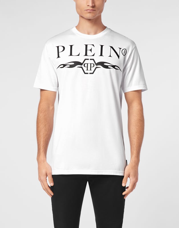 Bold and unapologetic, this round neck t-shirt channels street-luxe energy with graphic flames and signature logo detailing ,  a must-have for statement layering.   Crafted from premium cotton for elevated comfort.   Bold logo and flame artwork create visual impact.   Classic fit ideal for everyday styling.   Hexagon emblem adds a touch of brand identity.   Pairs effortlessly with denim, joggers, or layered under a jacket.