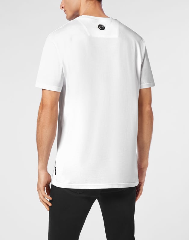Bold and unapologetic, this round neck t-shirt channels street-luxe energy with graphic flames and signature logo detailing ,  a must-have for statement layering.   Crafted from premium cotton for elevated comfort.   Bold logo and flame artwork create visual impact.   Classic fit ideal for everyday styling.   Hexagon emblem adds a touch of brand identity.   Pairs effortlessly with denim, joggers, or layered under a jacket.