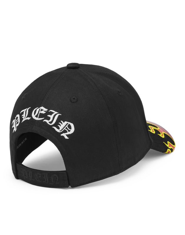 Complemente su look con esta gorra de béisbol que presenta los elementos icónicos de la marca. Descubra más.   Sarga de algodón   Letras de estilo gótico bordadas en la parte delantera   Llamas bordadas en la visera.  Letras bordadas en la espalda.  Correa de velcro ajustable