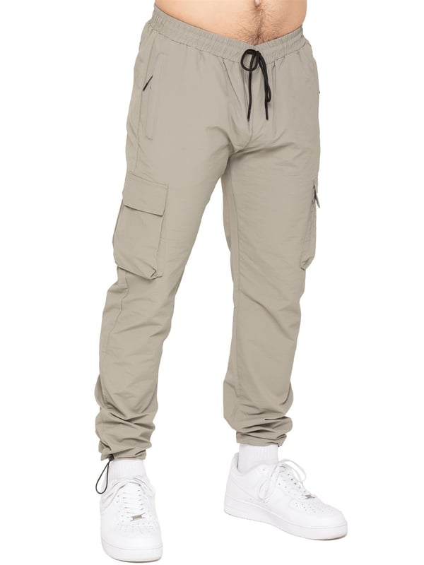 Stay ready for anything with the Enzo Milano Men’s Cargo Pants. Made from lightweight, poly fabric, these straight-leg trousers feature a regular fit, elasticated waistband with adjustable drawstring, and drawstring hems for a custom fit. With two Velcro-fastened side cargo pockets and a back welt pocket, they offer secure, practical storage. Perfect for everyday wear, travel, or outdoor use, these men’s cargo pants combine comfort, function, and style.