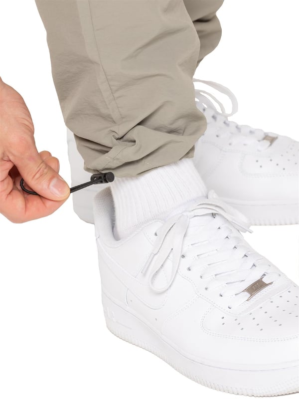 Stay ready for anything with the Enzo Milano Men’s Cargo Pants. Made from lightweight, poly fabric, these straight-leg trousers feature a regular fit, elasticated waistband with adjustable drawstring, and drawstring hems for a custom fit. With two Velcro-fastened side cargo pockets and a back welt pocket, they offer secure, practical storage. Perfect for everyday wear, travel, or outdoor use, these men’s cargo pants combine comfort, function, and style.