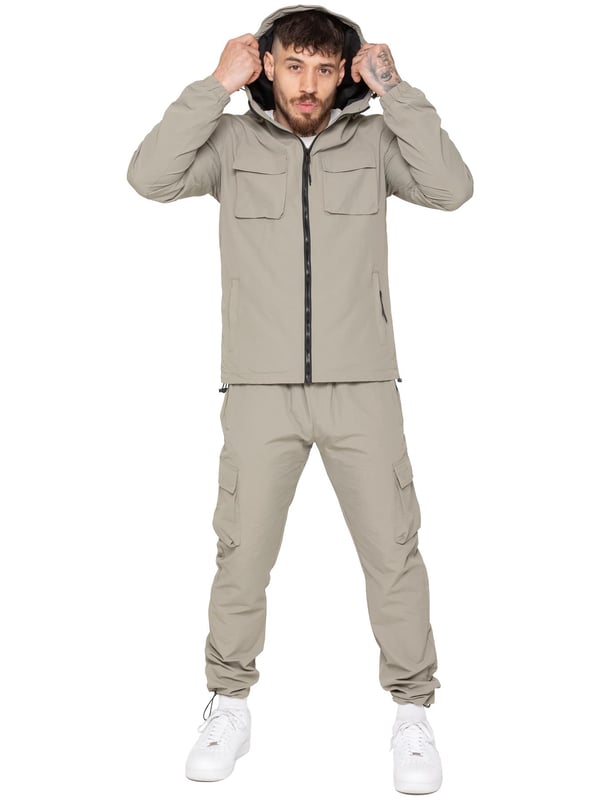 Stay ready for anything with the Enzo Milano Men’s Cargo Pants. Made from lightweight, poly fabric, these straight-leg trousers feature a regular fit, elasticated waistband with adjustable drawstring, and drawstring hems for a custom fit. With two Velcro-fastened side cargo pockets and a back welt pocket, they offer secure, practical storage. Perfect for everyday wear, travel, or outdoor use, these men’s cargo pants combine comfort, function, and style.
