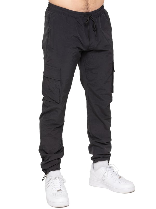 Stay ready for anything with the Enzo Milano Men’s Cargo Pants. Made from lightweight, poly fabric, these straight-leg trousers feature a regular fit, elasticated waistband with adjustable drawstring, and drawstring hems for a custom fit. With two Velcro-fastened side cargo pockets and a back welt pocket, they offer secure, practical storage. Perfect for everyday wear, travel, or outdoor use, these men’s cargo pants combine comfort, function, and style.