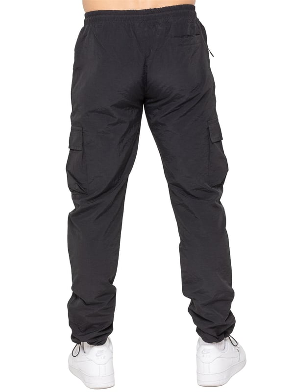 Stay ready for anything with the Enzo Milano Men’s Cargo Pants. Made from lightweight, poly fabric, these straight-leg trousers feature a regular fit, elasticated waistband with adjustable drawstring, and drawstring hems for a custom fit. With two Velcro-fastened side cargo pockets and a back welt pocket, they offer secure, practical storage. Perfect for everyday wear, travel, or outdoor use, these men’s cargo pants combine comfort, function, and style.