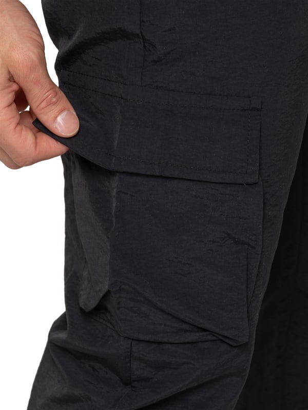 Stay ready for anything with the Enzo Milano Men’s Cargo Pants. Made from lightweight, poly fabric, these straight-leg trousers feature a regular fit, elasticated waistband with adjustable drawstring, and drawstring hems for a custom fit. With two Velcro-fastened side cargo pockets and a back welt pocket, they offer secure, practical storage. Perfect for everyday wear, travel, or outdoor use, these men’s cargo pants combine comfort, function, and style.