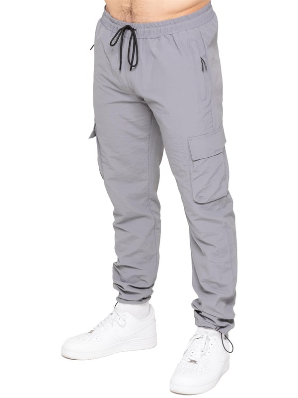 Stay ready for anything with the Enzo Milano Men’s Cargo Pants. Made from lightweight, poly fabric, these straight-leg trousers feature a regular fit, elasticated waistband with adjustable drawstring, and drawstring hems for a custom fit. With two Velcro-fastened side cargo pockets and a back welt pocket, they offer secure, practical storage. Perfect for everyday wear, travel, or outdoor use, these men’s cargo pants combine comfort, function, and style.
