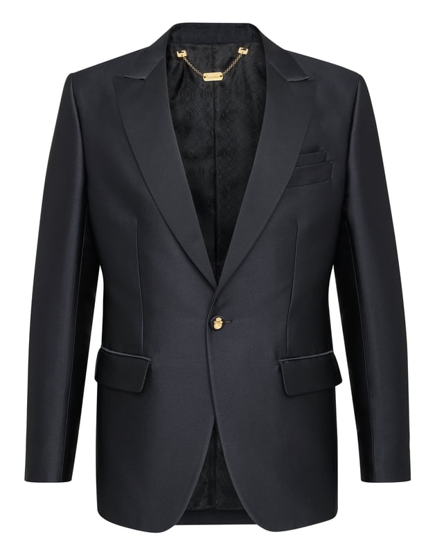Special events need a dash of originality, like this single button evening jacket. It is made of viscose satin and acetate and decorated with the brand's iconic coat-of-arms embroidered on the back. Satin peak lapel and on pockets' flaps. Satin lined buttons with the brand's metal coat-of-arms. Two slits on the back. Inner lining.