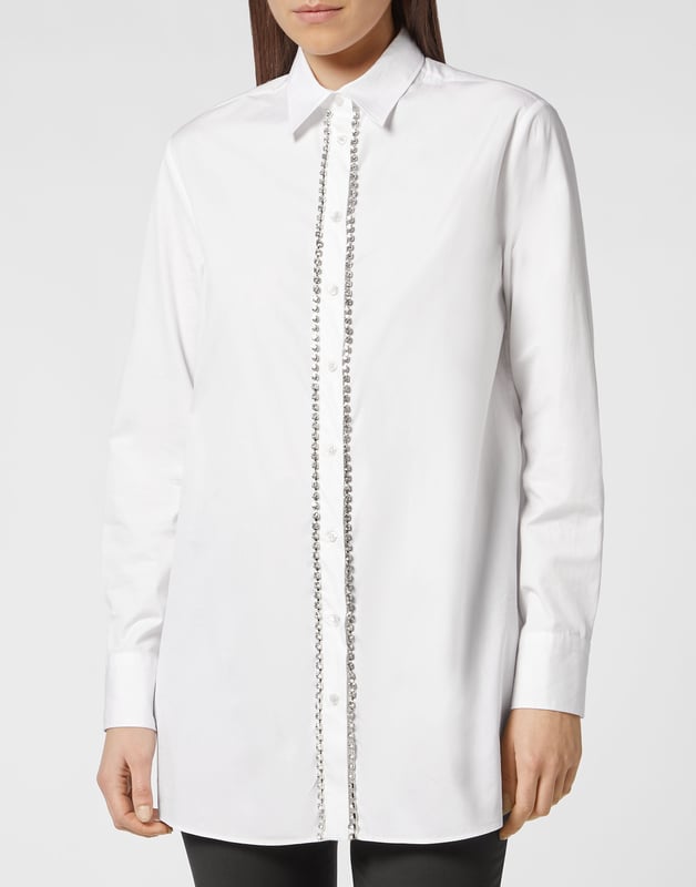 con cristales  Las líneas limpias de este vestido camisero de popelina de algodón se ven realzadas por los cristales de strass que decoran la tapeta y los puños. La marca escrita en strass en el dobladillo inferior trasero es el toque definitivo de singularidad.