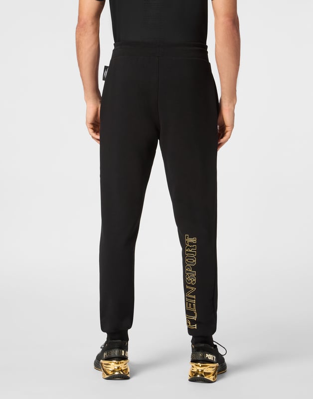 Estos pantalones de jogging diseñados para cualquier entrenamiento, son el complemento perfecto para alcanzar tus objetivos. Comodidad y rendimiento se suman al estilo de Plein Sport.   Forro polar de algodón   Patrón estampado en la parte delantera y trasera   Cintura de punto elástico con cordón   Parche cosido en la pernera izquierda   Dos bolsillos con aberturas   Puños inferiores de punto elástico.
