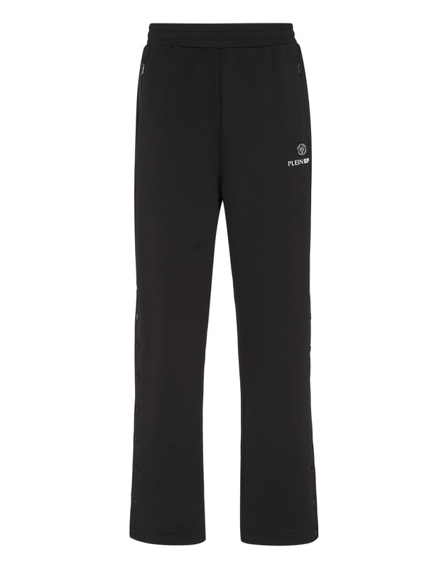 Estos pantalones de entrenamiento son el complemento perfecto para alcanzar tus objetivos. Comodidad y rendimiento se suman al estilo de Plein Sport.   Tejido técnico polar   Detalles Framis   Cintura ealstica   Estampado de letras en la pierna izquierda   Dos bolsillos con aberturas   Perneras con abertura lateral y botones a presión   Corte holgado para mayor comodidad   Costura a dos agujas