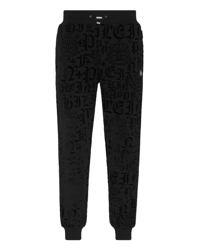 Defina su estilo con un toque de personalidad. Luzca este pantalón jogging de forro polar de algodón con un original estampado.    Suave forro polar de mezcla de algodón.   Estampado de letras flocadas por toda la prenda    Hexágono de PP en una insignia de cuero saffiano cosida en el lateral izquierdo   Bolsillos con aberturas   Cintura parcialmente de nailon elástico con cordón de tope   Puños de punto elástico