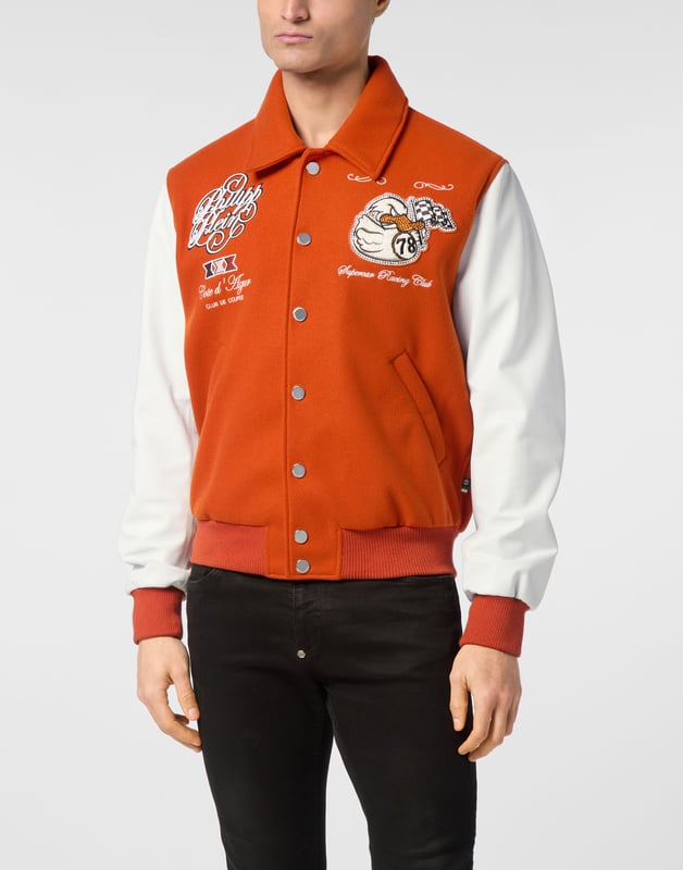Add something unique and distinctive to your wardrobe. We suggest this varsity jacket.   Wool fabric   Leather   Embroidered patches sewn on the front and the back   Rhinestones applications   Embroidered details   Shirt collar   Snap buttons fastening   Two slit pockets   Rib knit tipping hems   Diamond quilted satin lining