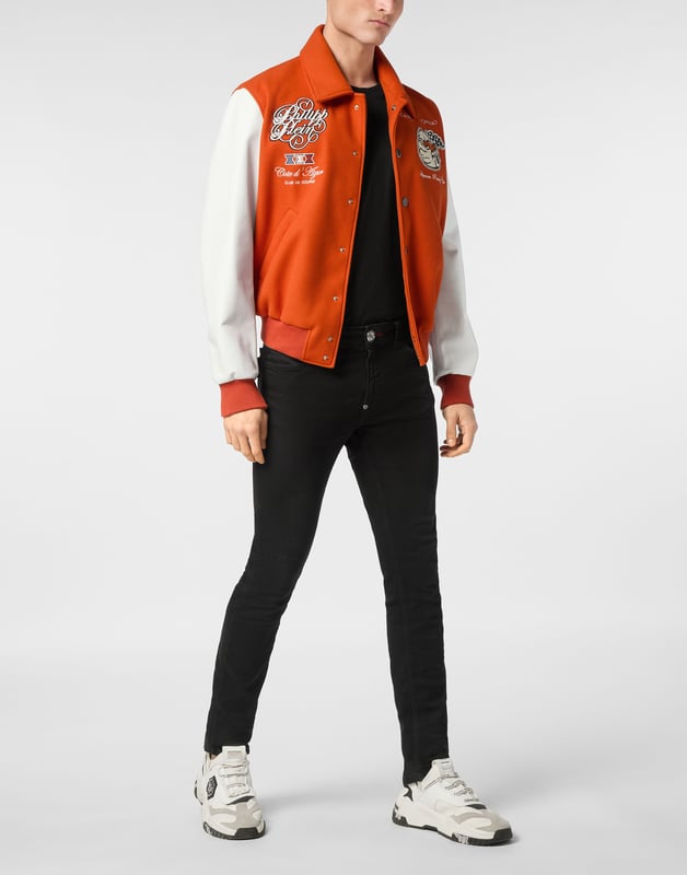 Add something unique and distinctive to your wardrobe. We suggest this varsity jacket.   Wool fabric   Leather   Embroidered patches sewn on the front and the back   Rhinestones applications   Embroidered details   Shirt collar   Snap buttons fastening   Two slit pockets   Rib knit tipping hems   Diamond quilted satin lining