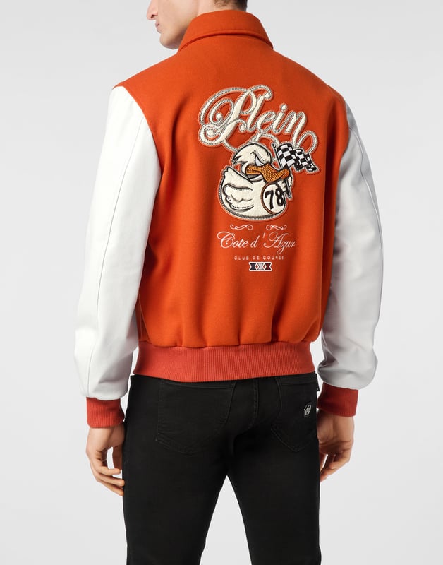 Add something unique and distinctive to your wardrobe. We suggest this varsity jacket.   Wool fabric   Leather   Embroidered patches sewn on the front and the back   Rhinestones applications   Embroidered details   Shirt collar   Snap buttons fastening   Two slit pockets   Rib knit tipping hems   Diamond quilted satin lining
