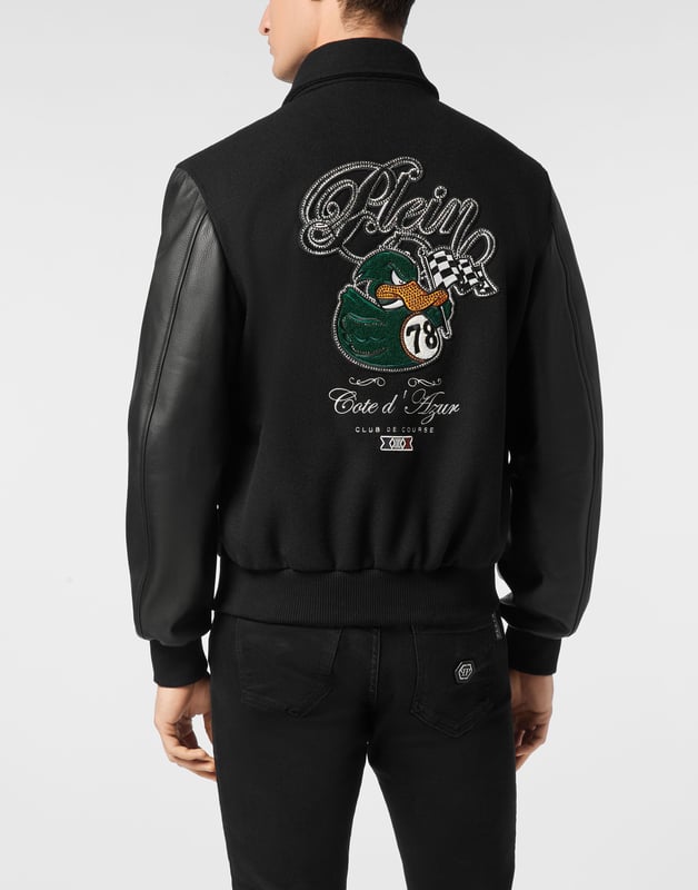 Add something unique and distinctive to your wardrobe. We suggest this varsity jacket.   Wool fabric   Leather   Embroidered patches sewn on the front and the back   Rhinestones applications   Embroidered details   Shirt collar   Snap buttons fastening   Two slit pockets   Rib knit tipping hems   Diamond quilted satin lining
