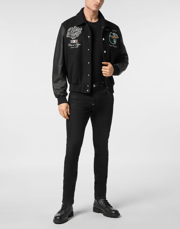 Add something unique and distinctive to your wardrobe. We suggest this varsity jacket.   Wool fabric   Leather   Embroidered patches sewn on the front and the back   Rhinestones applications   Embroidered details   Shirt collar   Snap buttons fastening   Two slit pockets   Rib knit tipping hems   Diamond quilted satin lining