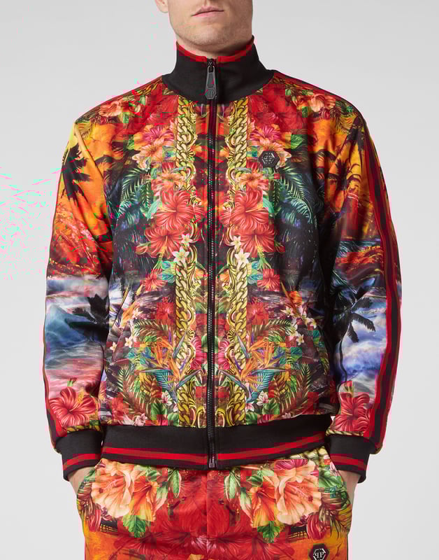 Choose to jog in style with the uniqueness identifying the style of Plein. We designed this techno fabric tracksuit featuring a Hawaii-themed print throughout.   Hawaii-inspired print triacetate   Contrasting sidebands on sleeves and outseam   Zip-up sweatjacket with PP Hexagon on a saffian leather patch sewn at left chest   Two slit pockets   PP Hexagon on a saffian leather badge sewn on the left side of pants   Slit pockets   Waistband with stop-cord drawstring   Rib knit hems