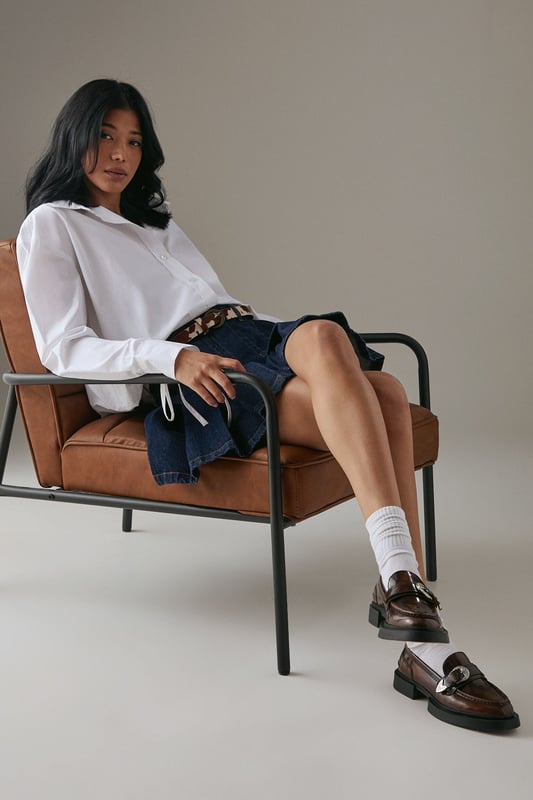Genuine leather upper for durability and style
        Western-inspired buckle detail adds a unique touch
        Chunky sole provides comfort and a trendy look
        Flat heel (0-2cm) ensures all-day wearability
        Versatile loafer design suitable for various occasions
    
    Step out in confidence with these Faith for Warehouse leather loafers. The western buckle detail adds a dash of intrigue to the classic silhouette, while the chunky sole offers both style and substance. Perfect for the fashion-forward woman who values comfort without compromising on style. Pair these versatile flats with tailored trousers and a crisp white shirt for a smart casual look at the office, or team them with a flowing midi dress for weekend brunches. The rich leather upper will develop a beautiful patina over time, making these loafers a cherished addition to your wardrobe. Whether you're navigating city streets or attending casual gatherings, these loafers will keep you looking polished and feeling comfortable all day long.